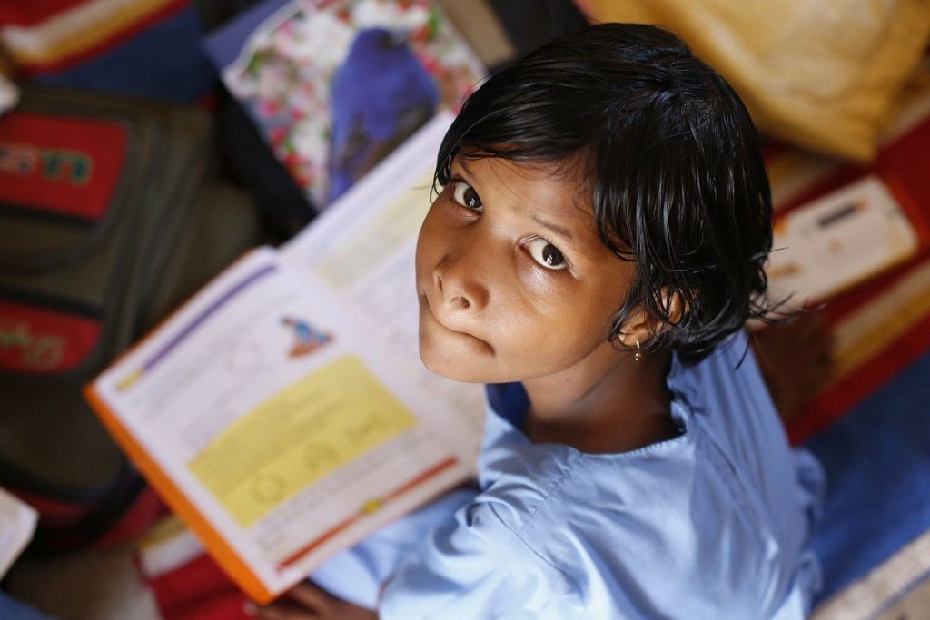 Una bambina indiana attiva sui libri di scuola