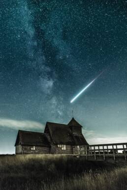 Night sky over the church Photo by Alexander Andrews on Unsplash