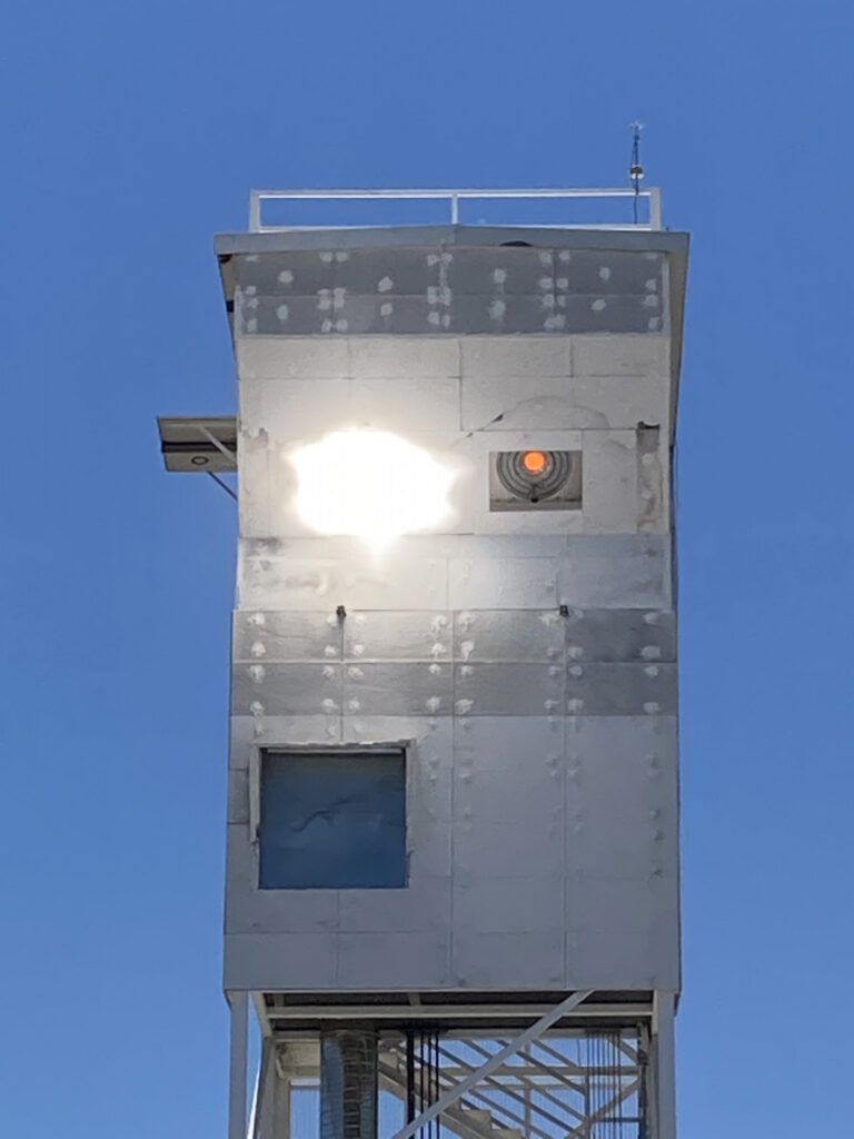 Synhelion’s solar receiver can be seen in the right aperture of the solar tower while the sunlight is being focused onto the calorimeter in the left aperture Source Synhelion