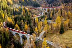 29OCT22 - Aerial photo of the world record attempt with the longest passenger train on the UNESCO World Heritage route 'Albula' on October 29, 2022 in Beguen in Graubuenden/Switzerland.